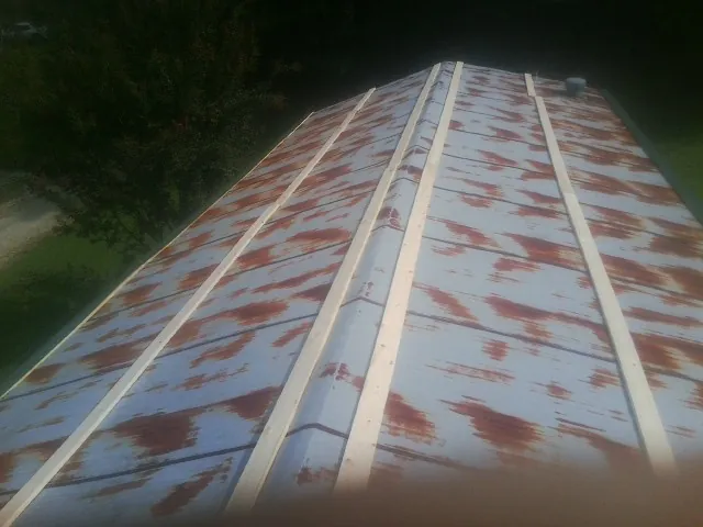 Rusted metal roof panels with new wood purlins before replacement — Storm Damage Roof Repair in Bloomingburg by Roofing Brothers